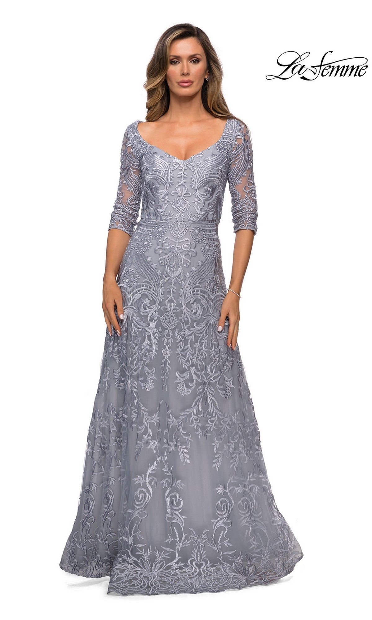 A floor-length silver Long Formal Dress: La Femme 27949 featuring a V-neckline, three-quarter sleeves, and intricate floral embroidery.